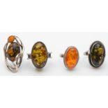 4 silver and amber set rings, 31g.