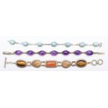 A silver and amethyst bracelet, a silver and hardstone bracelet and another silver set bracelet,