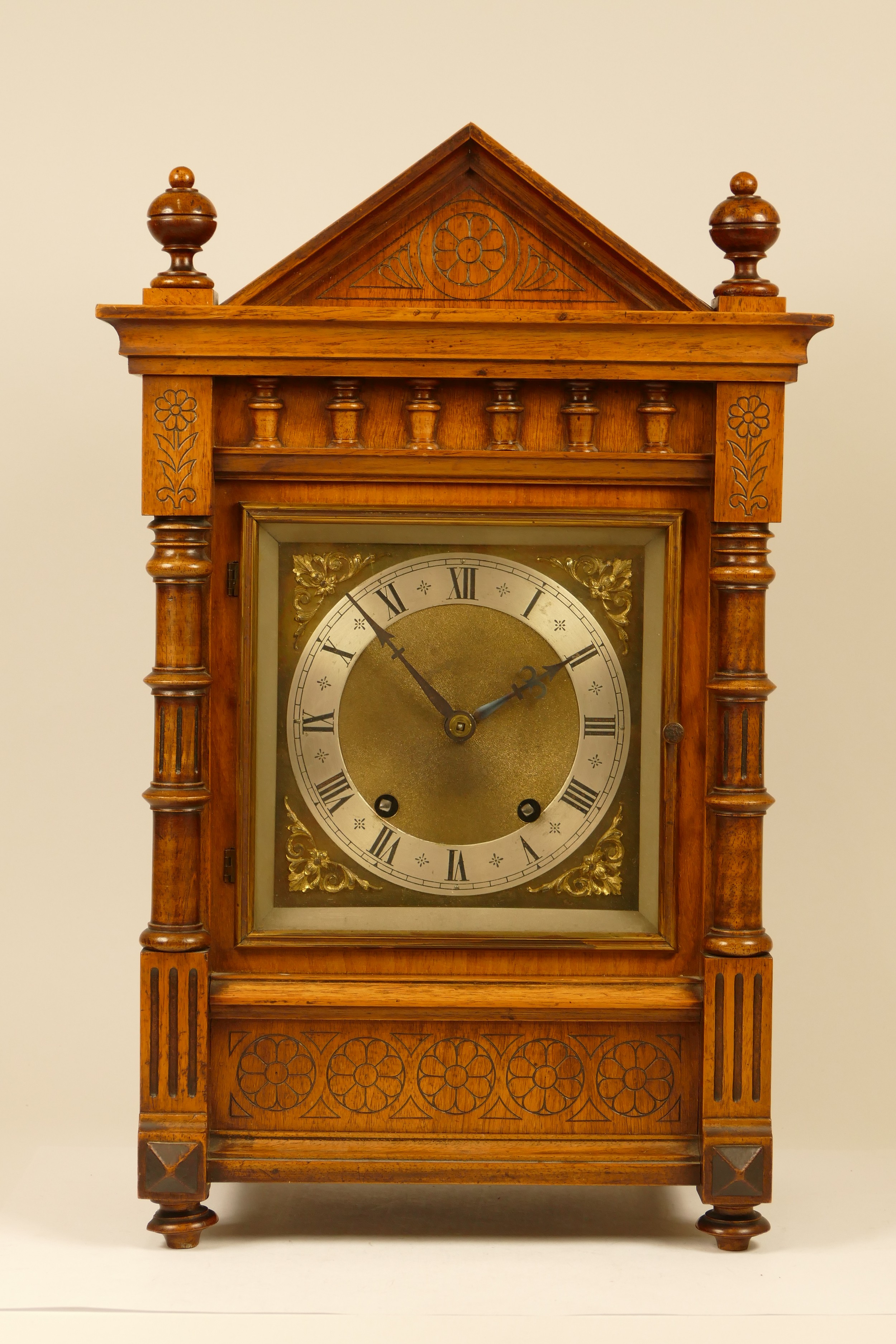 An early 20th century mahogany cased mantel clock, having architectural pediment with corinthium