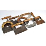 A collection of early and mid 20th century herb choppers, wooden handles with various shaped metal