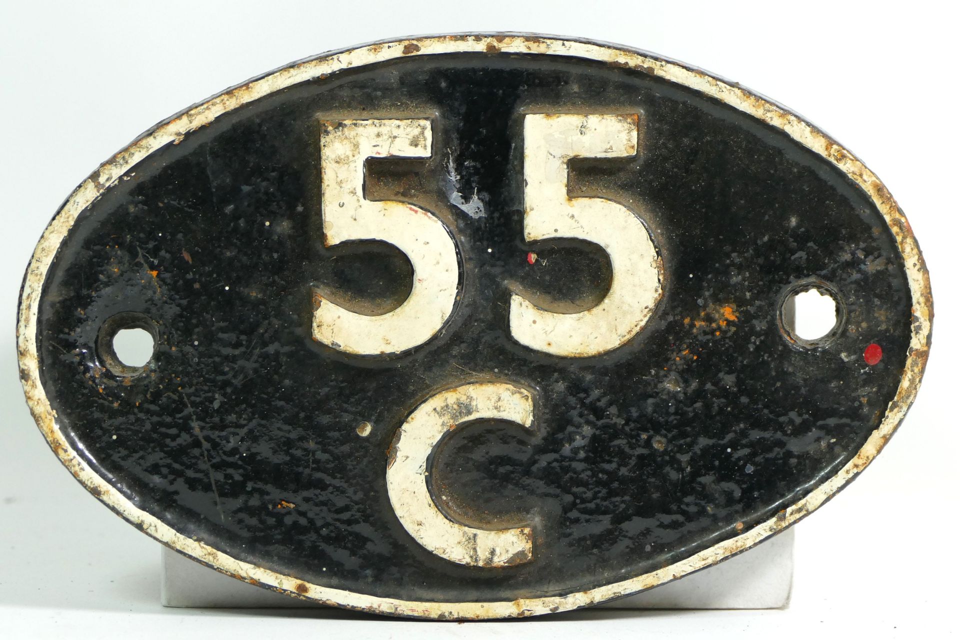 An oval cast iron shed plate, '55C Farnley Junction (Leeds)'.