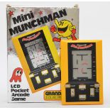 A Grandstand handheld pocket game, Mini Munchman, boxed