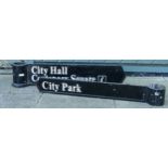Two directional signs, powder coated cast metal with painted lettering, pointed at one end and a