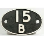 An oval cast iron shed plate, '15B Kettering'.