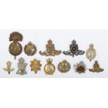 A collection of 12 military cap badges, to include RFC and the Scottish Fusiliers.