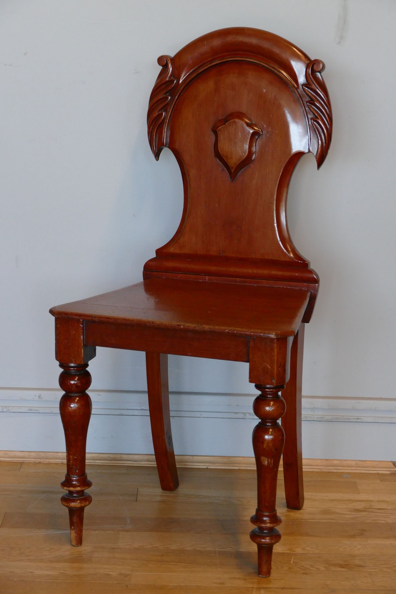 A G.W.R. station chair, label on base "G.W.R. to Swansea", with craved crest on backrest, tapered