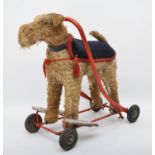 A ride on push along child's toy, in the form on a dog, westie, with collar and jacket, with
