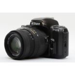 A Nikon F-601 35mm film camera, with a Sigma 55mm-200mm f4-f5.6 lens