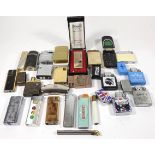 A collection of pocket cigarette lighters, primarily gas filled examples.