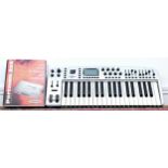 A M-Audio Ozonic 37 key midi control keyboard, with manual, together with a Portman 2x4 midi