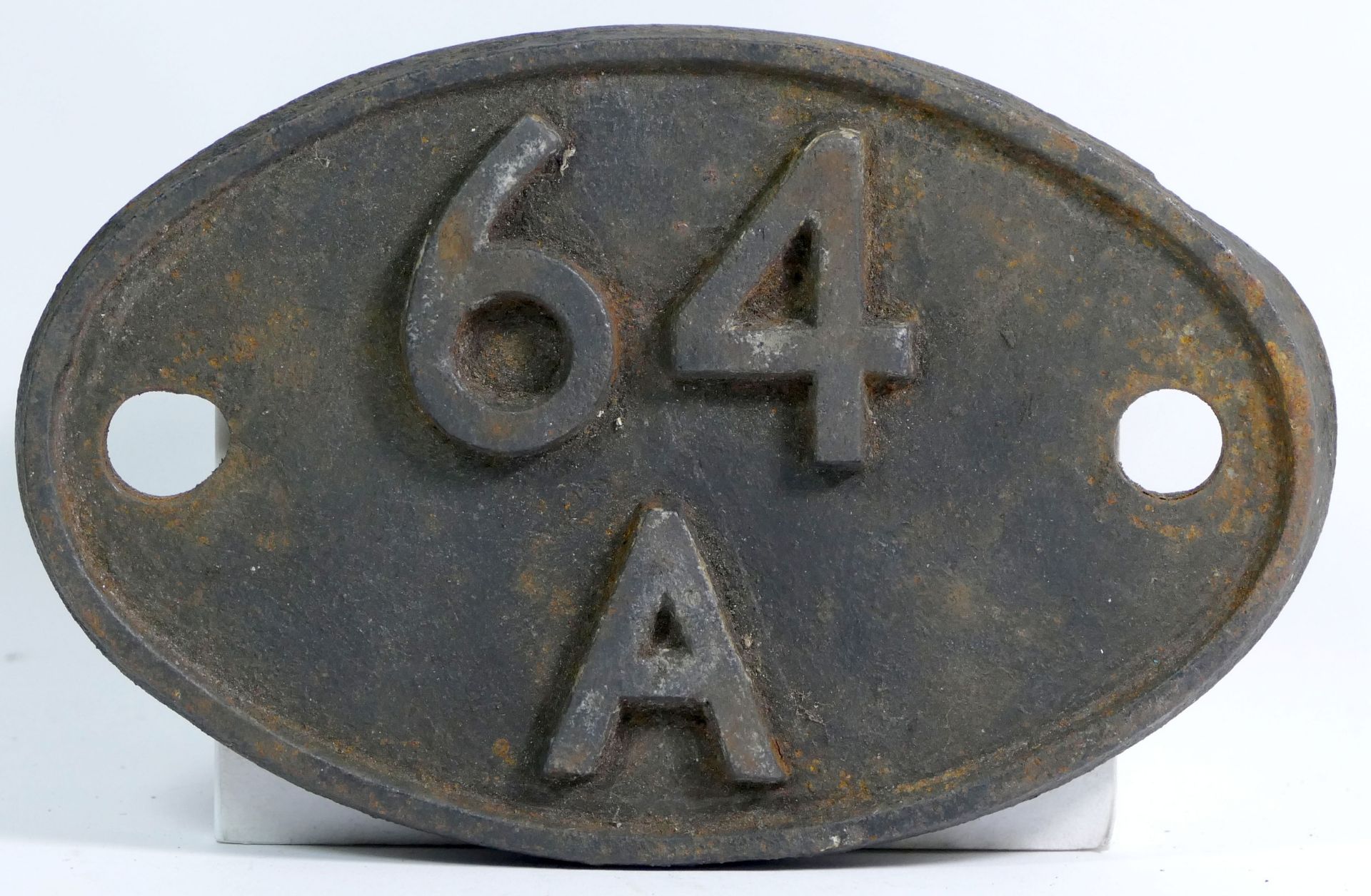An oval cast iron shed plate, '64A St. Margarets (Edinburgh)'.