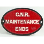 An oval cast iron sign, 'G.N.R. Maintenance Ends'.