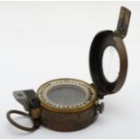 A WWII War Department military compass, by T.G. Co., Ltd, broad arrow and 1941 stamps