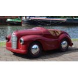 An Austin J40 pedal car, c.1948, offered in red, partially restored. The car was made from heavy-