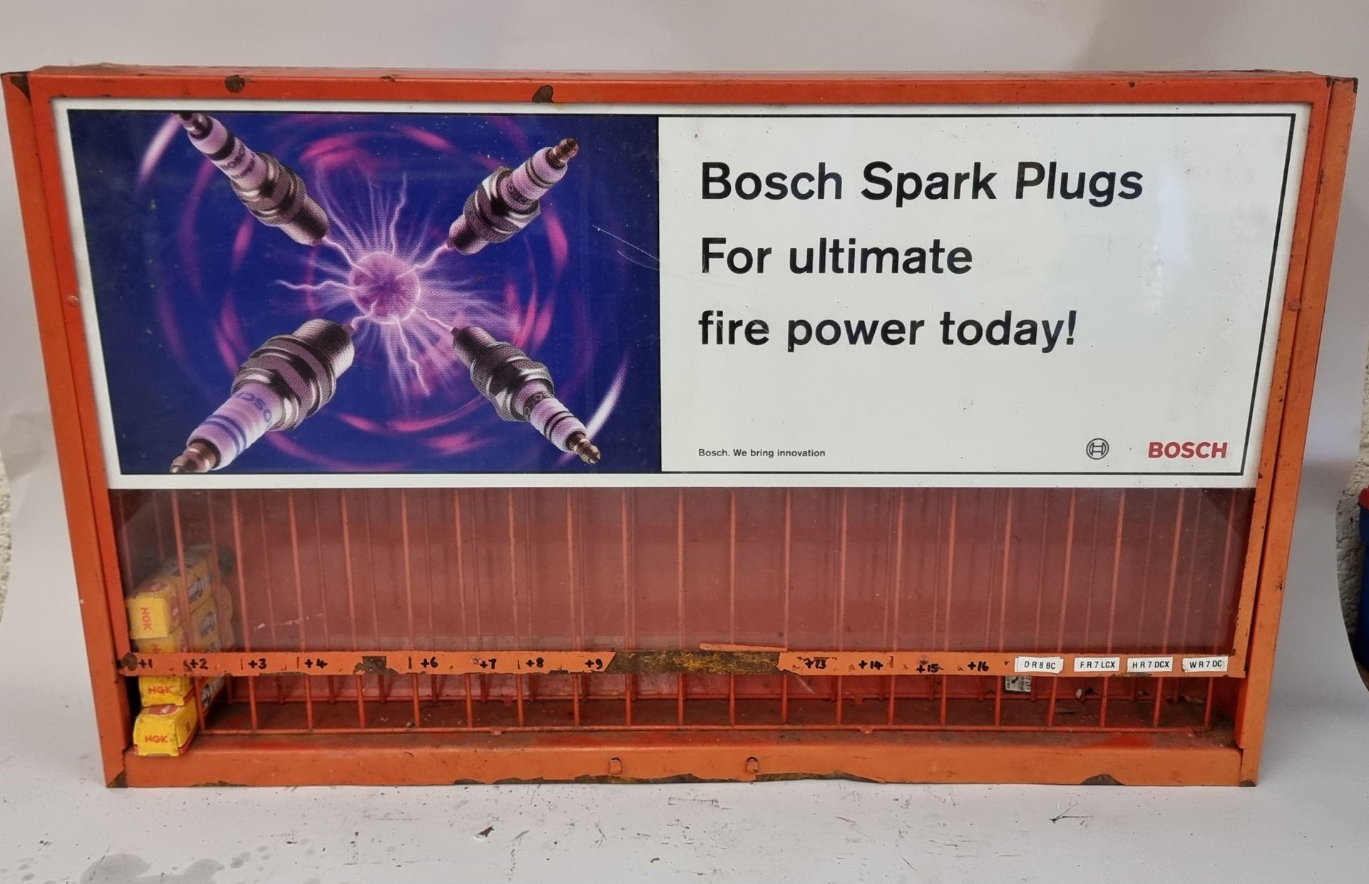 A Bosch spark plug wall mounted display stand, 67 x 11 x 40cm