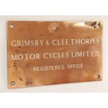 A vintage brass Grimsby & Cleethorpes Motorcycle Company wall plaque, 12.5 x 20cm