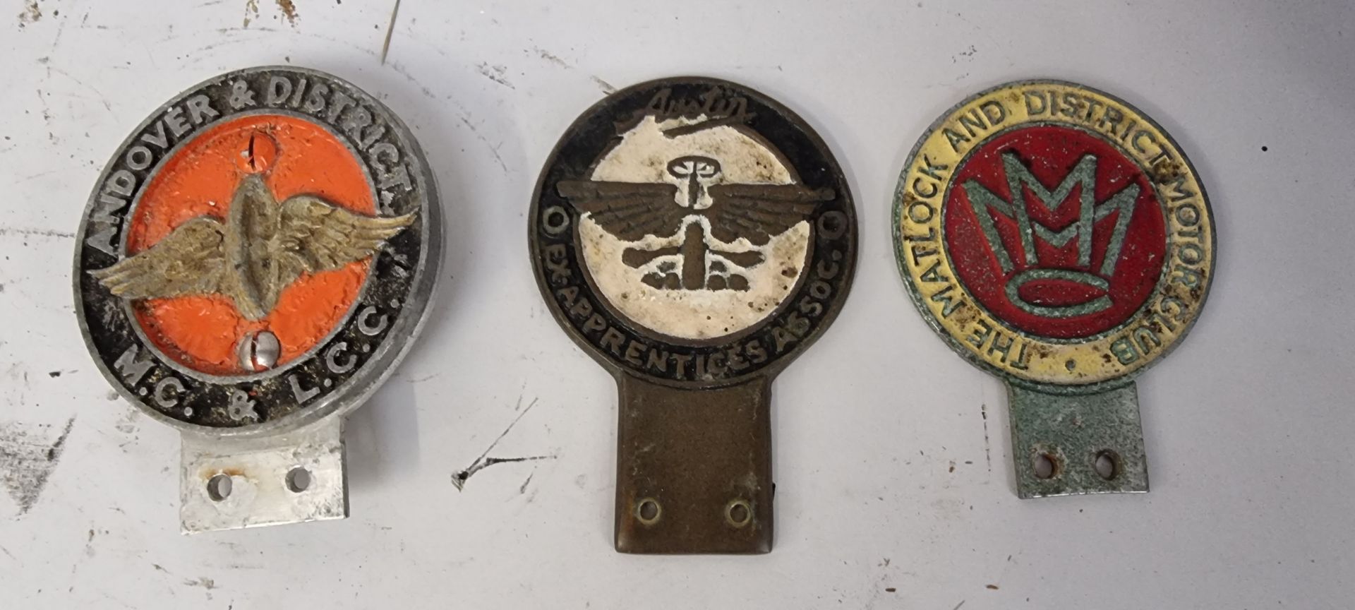 An Austin Ex Apprentices Assoc, badge and two other badges