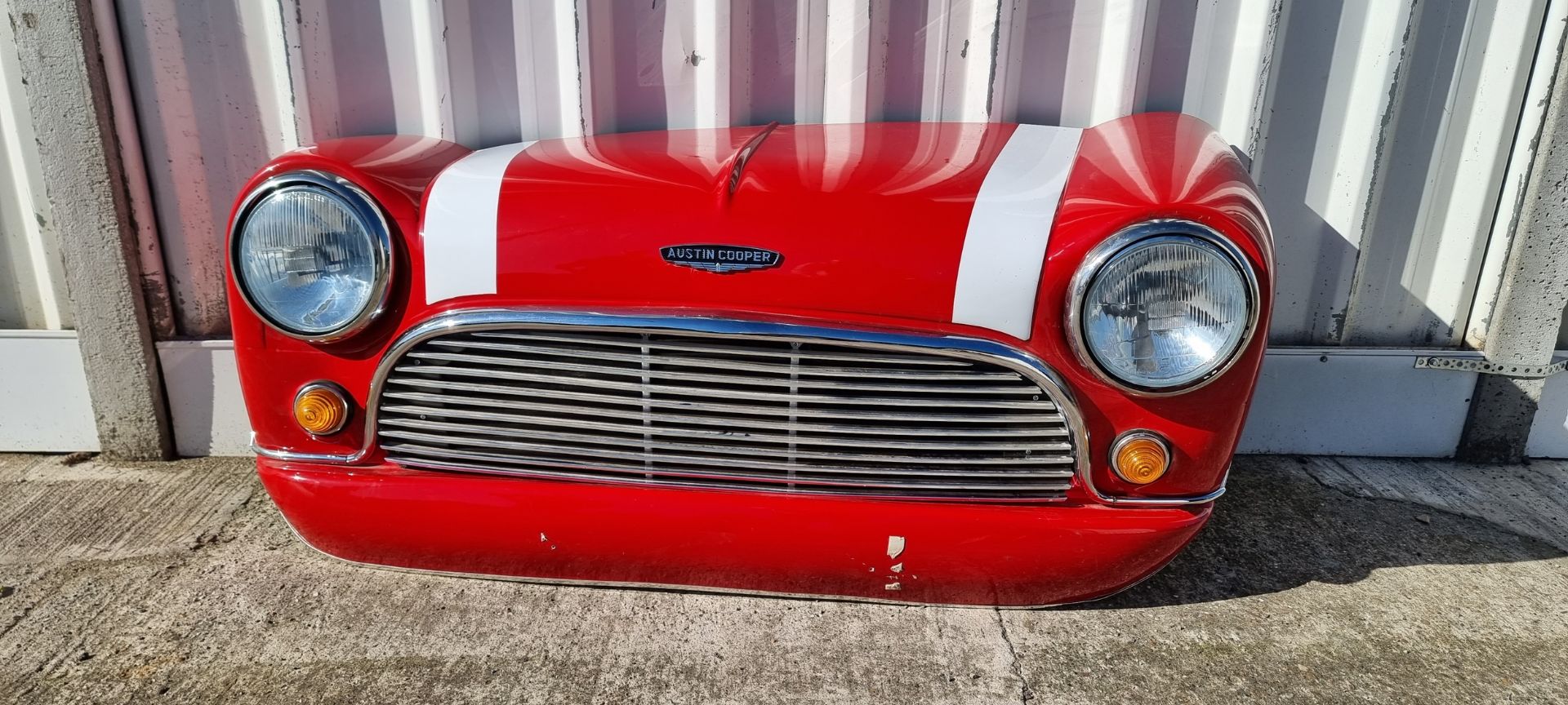 A fibreglass wall mounted Classic Mini Cooper front end, with lights