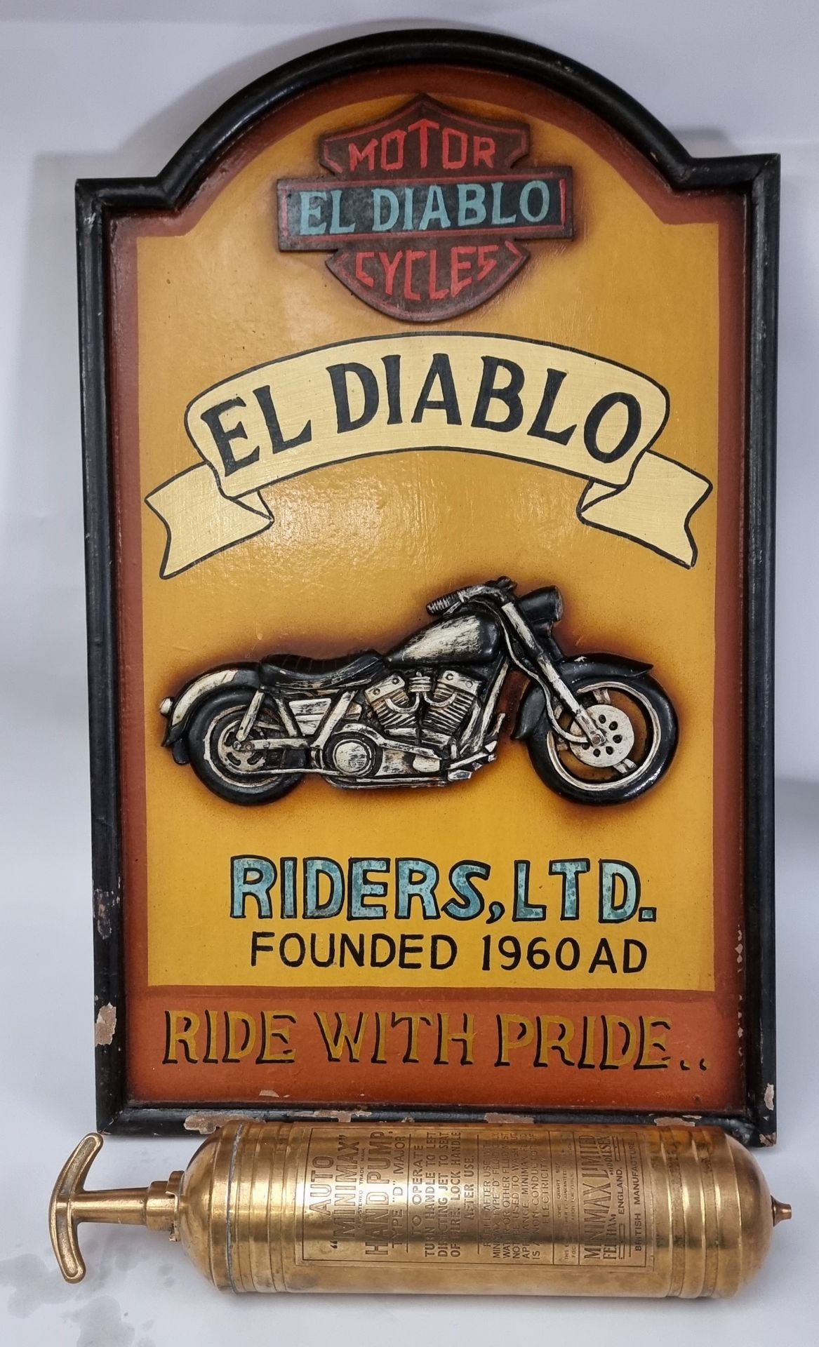 An El Diablo painted wooden motorcycle sign, 59 x 37cm, together with a brass Auto MiniMax Hand Pump
