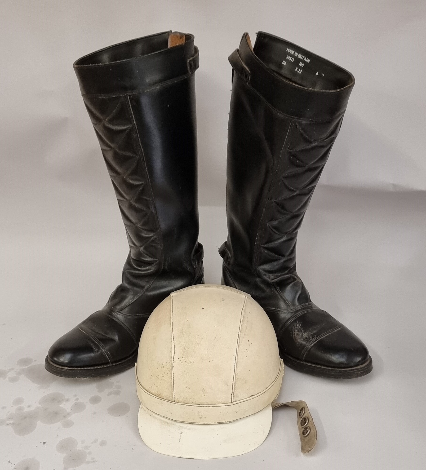 A Cromwell "The Noll" helmet, size 7 1/8, and a pair of Made in Britain leather riding boots, size 8