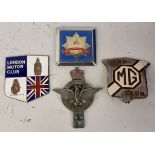 A Civil Service car badge and three other badges