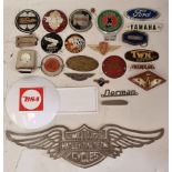 A collection of motorcar and motorcycle badges