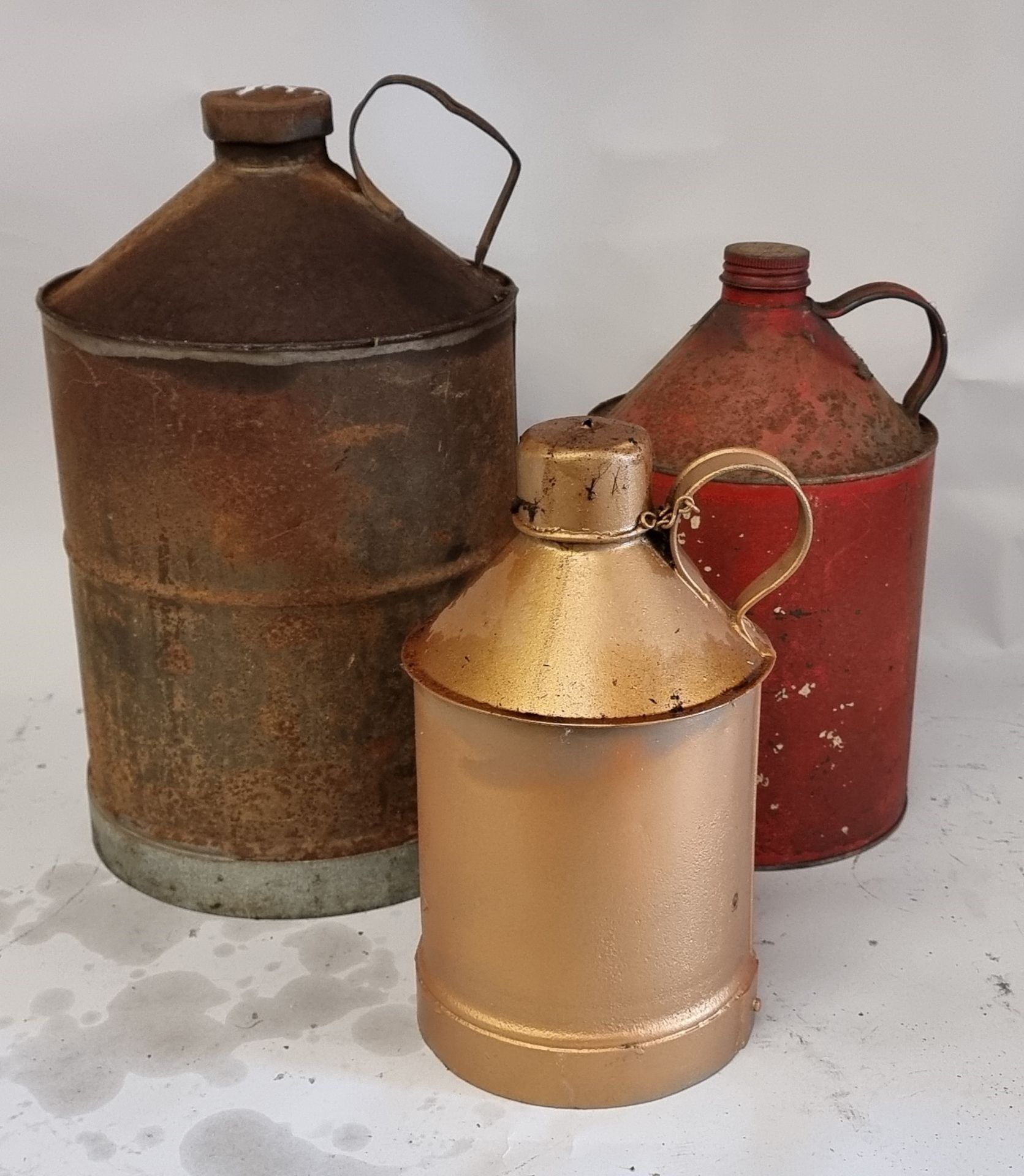 Three conical oil cans