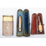 A silver slide action vesta case, London 1937, a silver cheroot holder, and an amber and
