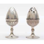 A silver pair of salt and pepper pots, by S. Mordan, London 1883, in the form of eggs in egg cups,