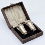 A silver and Bakelite pair of salt and pepper pots, Birmingham 1937, screw caps, 8cm, case