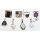 Four silver and gemstone set rings and four pendants, 83gm
