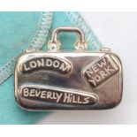 Tiffany & Co., Philippines, a silver suitcase pill box, with London, New York, Beverly Hills, Tokyo,