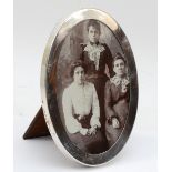 An oval silver photograph frame, Birmingham 1925, 17.5 x 13cm