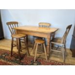 A country kitchen style pine table, on turned legs, 122 x 72 x 66cm, together with three pine dining