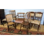 A harlequin set of seven chairs, to include a wicker backed rocking chair, four dining chairs with