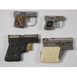 Four 1950/60s novelty petrol cigarette lighters in the forms of pistols. (4)