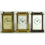 Two French brass 8 day carriage clocks, together with an English example. 12cm tall. (3)