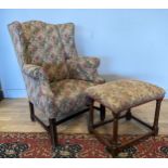 A mid 20th century mahogany framed armchair, scrolled back rest. padded upholstery