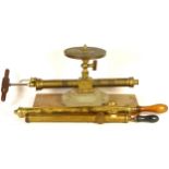 Two early 20th century brass syringe pumps, together with a tabletop example and a cased Dwyer