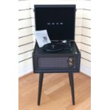 A Bush classics turntable, on four removable tapered legs, black leather effect finish, with