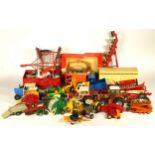 A collection of die-cast figures, mostly Britain's, including animals, farm equipment and machinery,