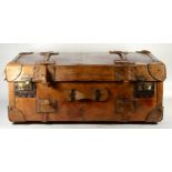 A late 19th century substantial tan leather traveling trunk/suitcase.