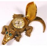 A novelty bedside/desk alarm clock in the form of a crocodile, gilt cast brass, top opening to