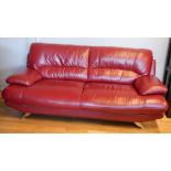 A red leather Italian style sofa, on chromed legs, 205 x 90 x 95cm