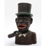 An early 20th century mechanical cast iron money bank 20cm tall.