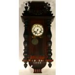 An early 20th century American drop dial wall clock, the walnut veneered case housing an eight day