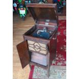 A Melodist freestanding record player, hinged doors open to reveal a speaker and lower shelf, on