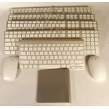 Four wired full sized Apple keyboards, a wireless apple keyboard, track pad, a Magic mouse and a