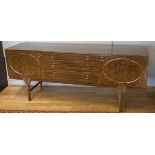 A unbranded 1960's sideboard, veneered front and top, with gild decorations, three graduated drawers