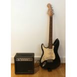 A Westwood electric guitar, start style body, black with cream coloured pick guard